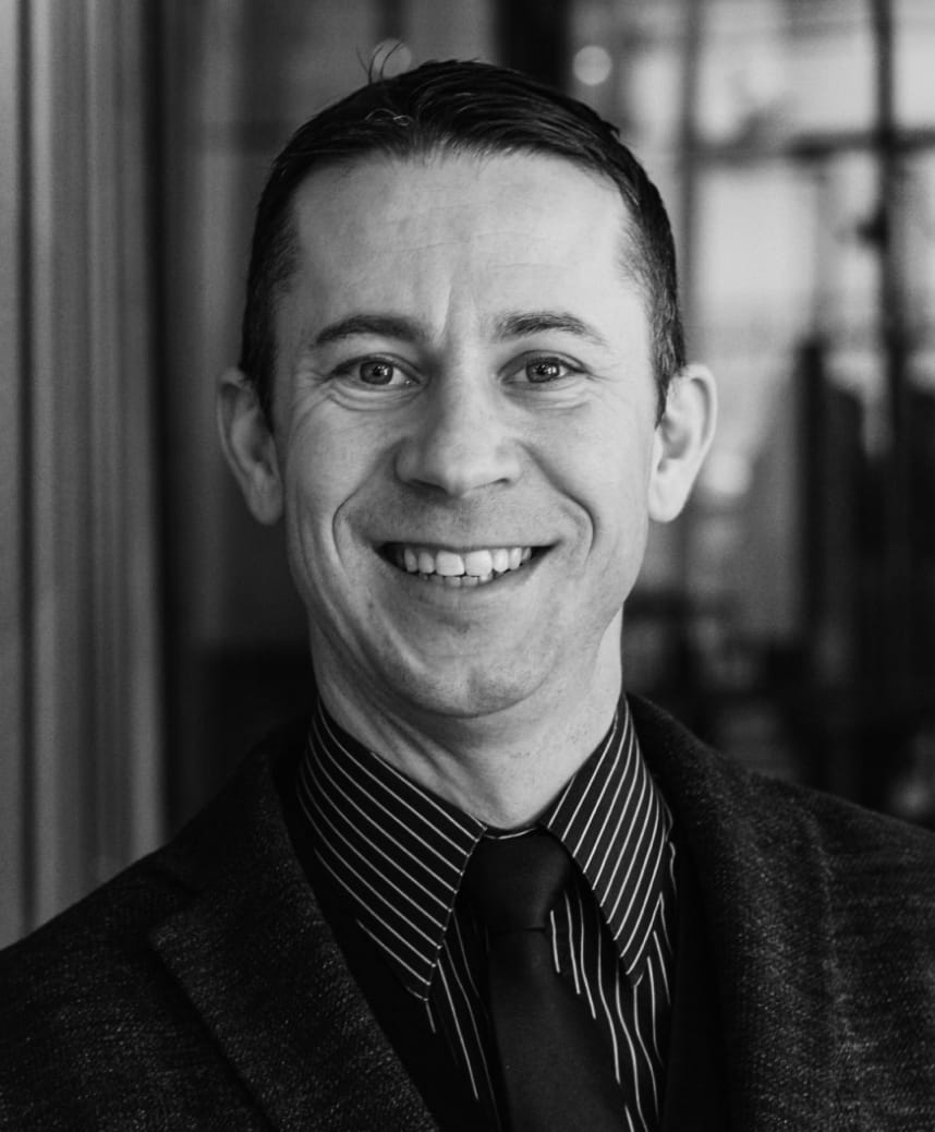Black and white professional headshot of David Brown